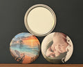 Two round photos with the third showing the back which is a pocket mirror, photographed on a dark background.