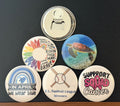 Collection of round images with one being the back which a magnetic bottle cap opener, photographed on a  dark background
