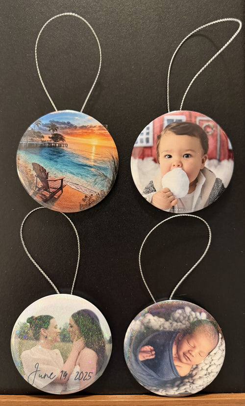 Four samples of circular photo holiday/Christmas ornaments with different images.  Clear or holographic covering available.  The ornaments are photographed against a black background.  