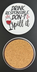 Round white drink coaster with cork backing with 'Drink Responsible Don't Spill It' in black text and a wine glass of red wine graphic on a black background.